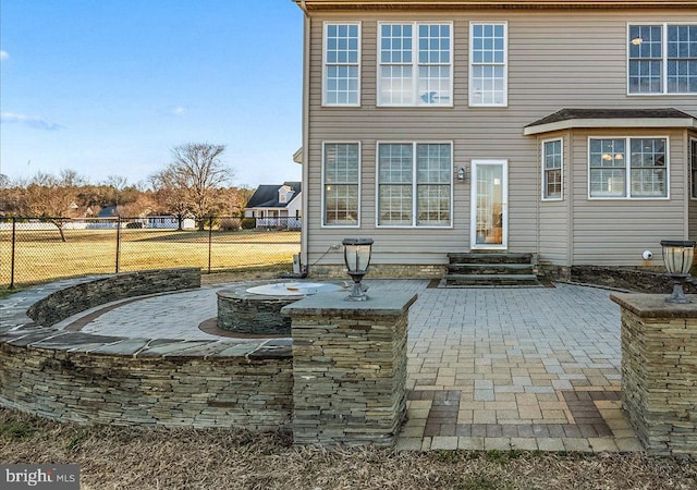 back of property featuring entry steps, a patio, and fence