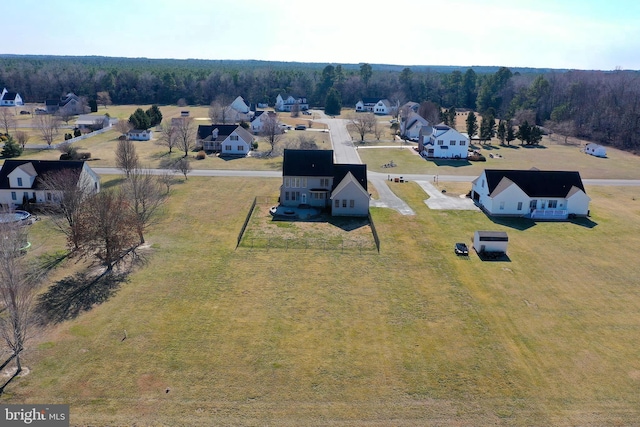 birds eye view of property with a residential view and a forest view