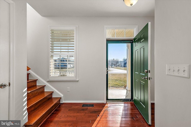 entryway featuring visible vents, stairs, baseboards, and hardwood / wood-style floors