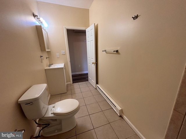 bathroom with baseboards, toilet, tile patterned floors, vanity, and a baseboard heating unit