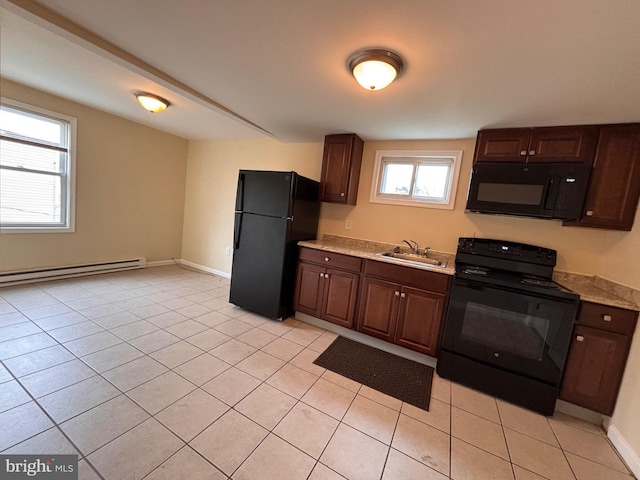 kitchen with a sink, black appliances, baseboard heating, and light countertops