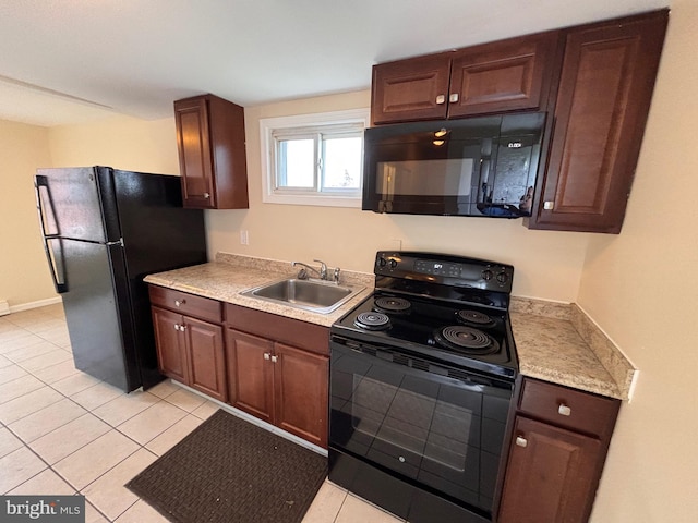 kitchen with black appliances, light tile patterned floors, light countertops, and a sink