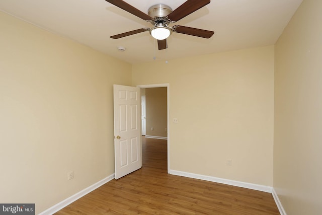 unfurnished room featuring wood finished floors and baseboards