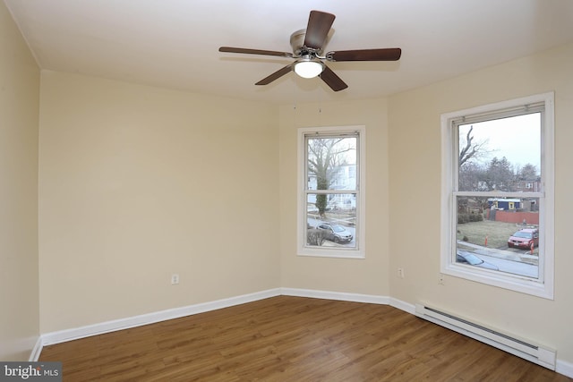 unfurnished room with a ceiling fan, baseboards, baseboard heating, and wood finished floors