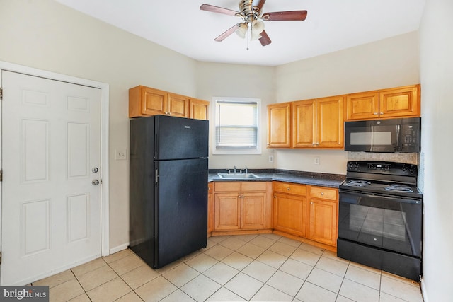 kitchen featuring light tile patterned floors, dark countertops, ceiling fan, black appliances, and a sink