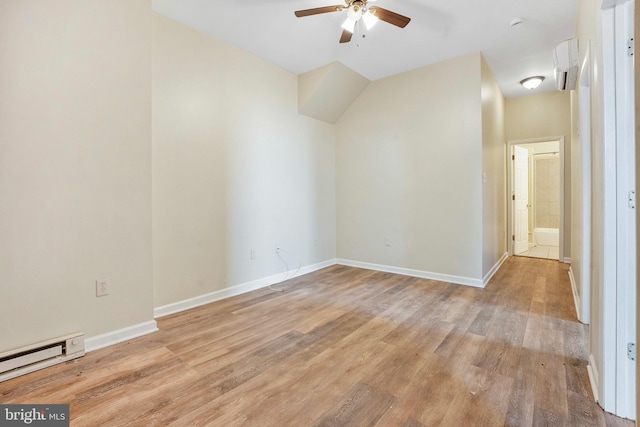 unfurnished room with ceiling fan, a baseboard radiator, baseboards, and light wood-style flooring