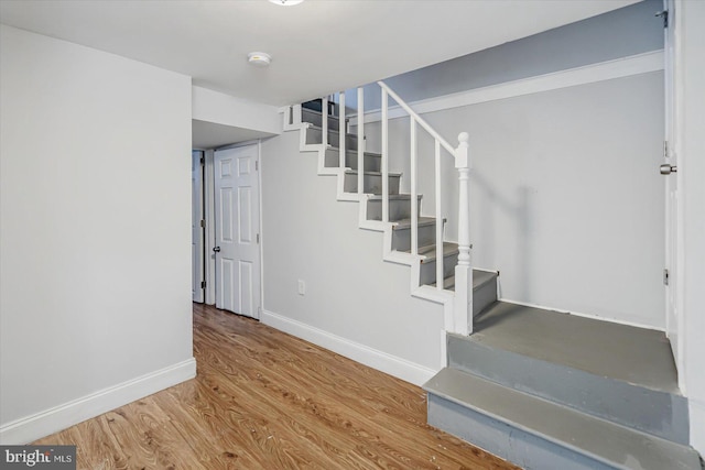 stairs featuring baseboards and wood finished floors