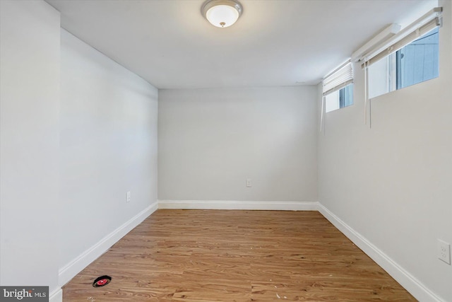 below grade area with light wood finished floors and baseboards