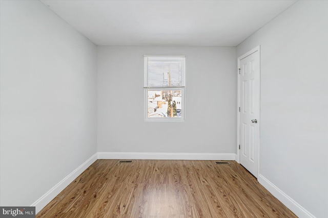 interior space featuring visible vents, baseboards, and wood finished floors