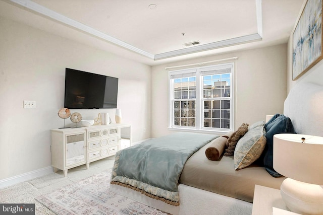 bedroom featuring carpet floors, a raised ceiling, visible vents, and baseboards