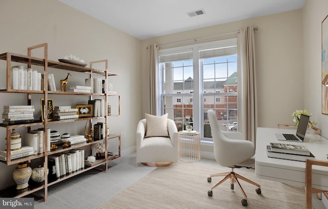 living area featuring baseboards and visible vents