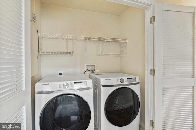 laundry room with laundry area and washing machine and clothes dryer