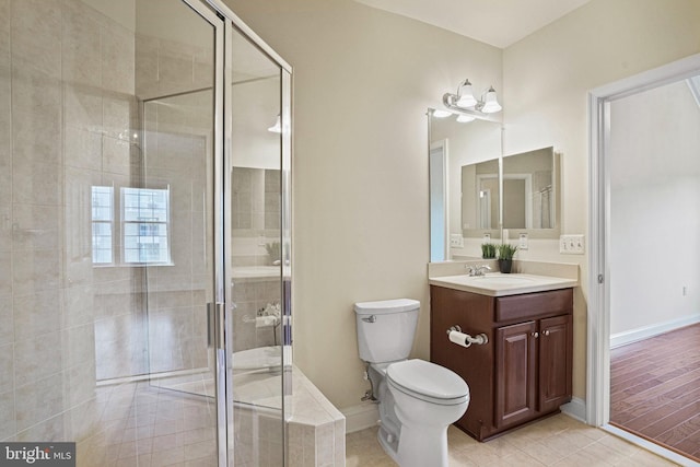 full bath with toilet, a stall shower, vanity, tile patterned flooring, and baseboards