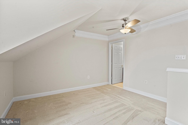 additional living space with lofted ceiling, baseboards, a ceiling fan, and light colored carpet