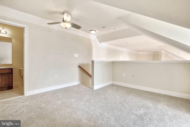 additional living space with a ceiling fan, lofted ceiling, light colored carpet, and baseboards