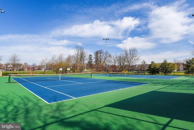 view of tennis court with fence