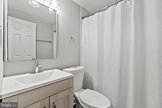 bathroom with toilet and vanity