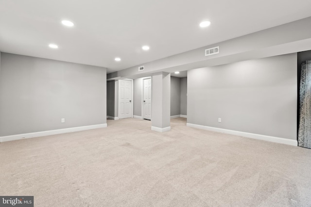 finished basement featuring recessed lighting, visible vents, and light colored carpet