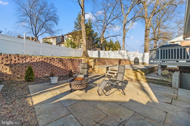 view of patio featuring a fenced backyard and a fire pit