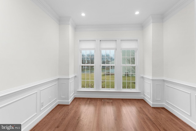 unfurnished room featuring ornamental molding, wood finished floors, and recessed lighting