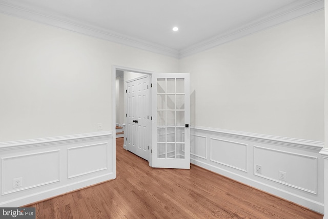 empty room with recessed lighting, light wood-style flooring, and crown molding