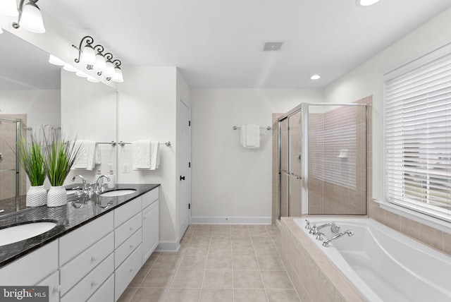 bathroom with double vanity, tile patterned floors, a sink, and a shower stall