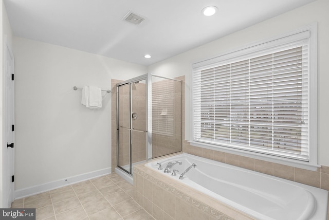 bathroom featuring visible vents, a shower stall, a bath, baseboards, and tile patterned floors