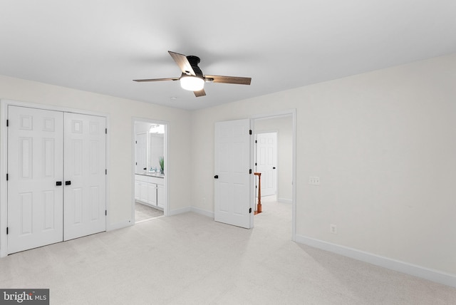 unfurnished bedroom featuring a closet, light colored carpet, and baseboards