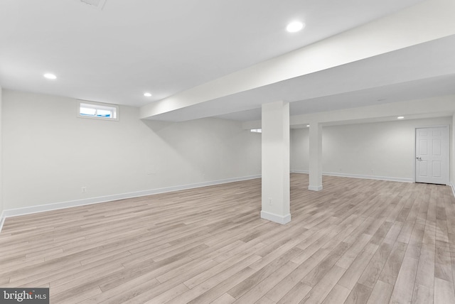 basement featuring light wood-type flooring, baseboards, and recessed lighting