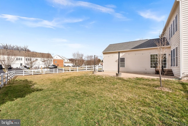 view of yard featuring entry steps, a patio area, and a fenced backyard