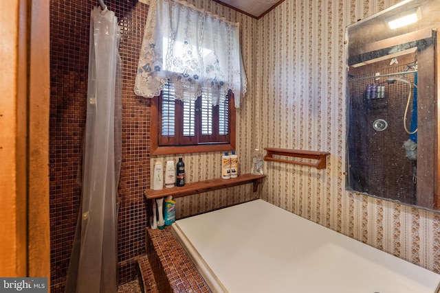 bathroom featuring wallpapered walls and a shower with curtain