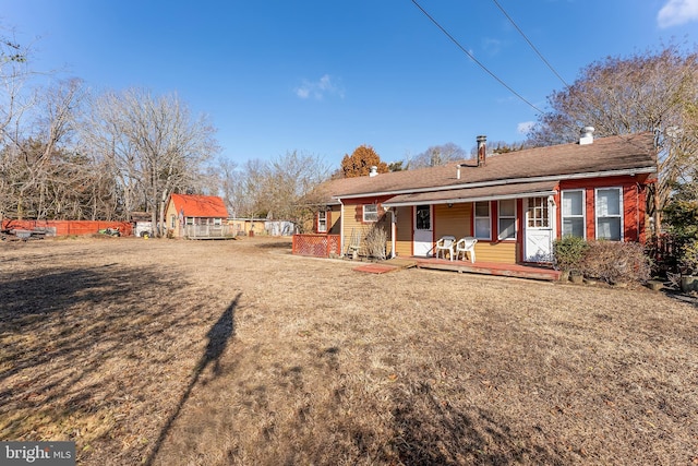 rear view of house featuring a porch