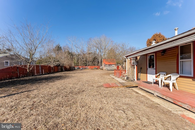 view of yard with a deck and fence