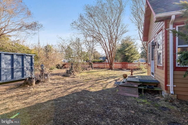 view of yard featuring a deck and fence