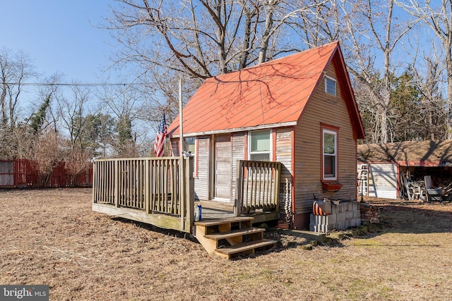 view of outbuilding featuring fence