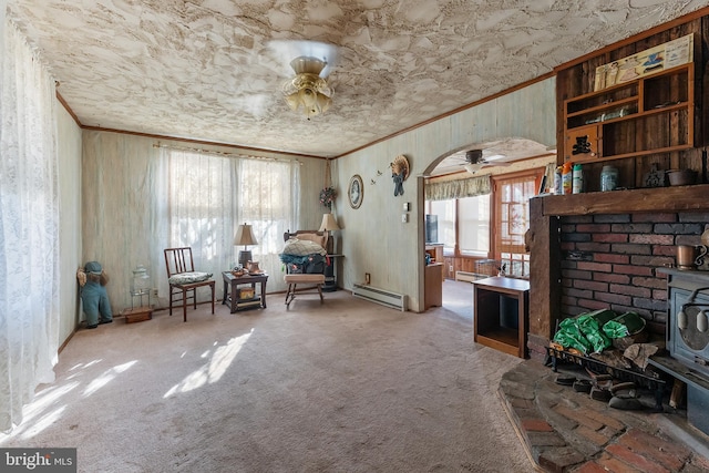 living area featuring arched walkways, a ceiling fan, a baseboard radiator, a wood stove, and crown molding