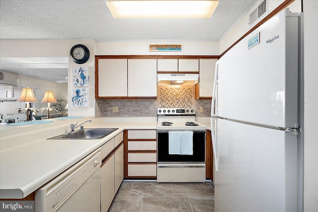 kitchen with visible vents, under cabinet range hood, a sink, white appliances, and light countertops