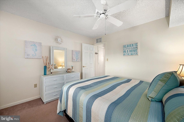 bedroom featuring visible vents, a textured ceiling, dark carpet, baseboards, and ceiling fan