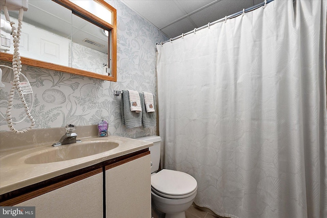 bathroom with visible vents, curtained shower, wallpapered walls, toilet, and vanity