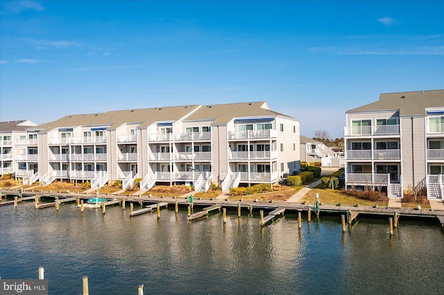 property view of water with a residential view and a boat dock