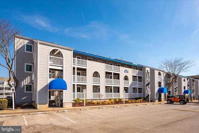 view of building exterior with uncovered parking