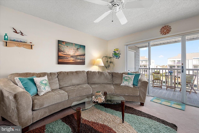 living room featuring carpet, vaulted ceiling, a ceiling fan, and a textured ceiling