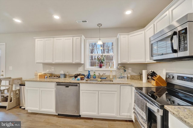 kitchen featuring recessed lighting, a sink, visible vents, white cabinetry, and appliances with stainless steel finishes