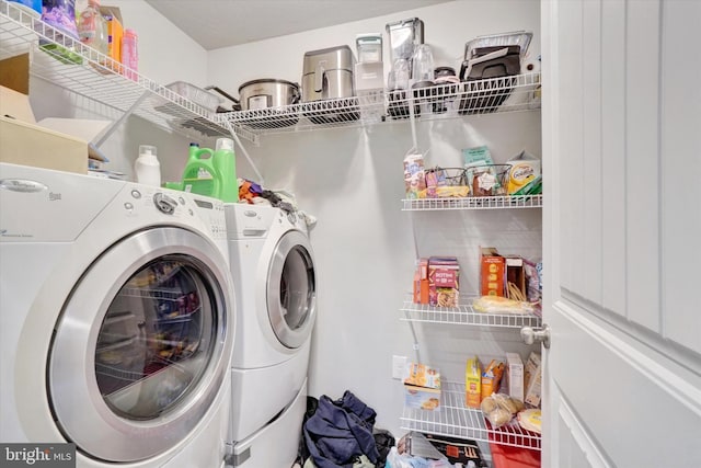 clothes washing area featuring laundry area and washer and dryer