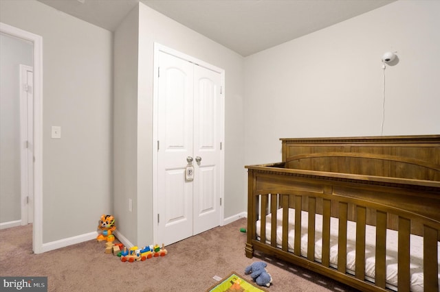 bedroom with carpet, a closet, and baseboards