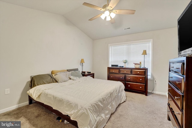 bedroom featuring light colored carpet, visible vents, vaulted ceiling, and baseboards