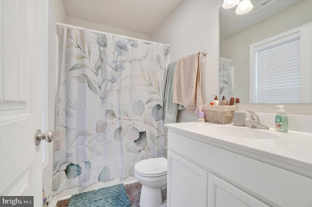 full bathroom featuring shower / tub combo with curtain, vanity, toilet, and wood finished floors