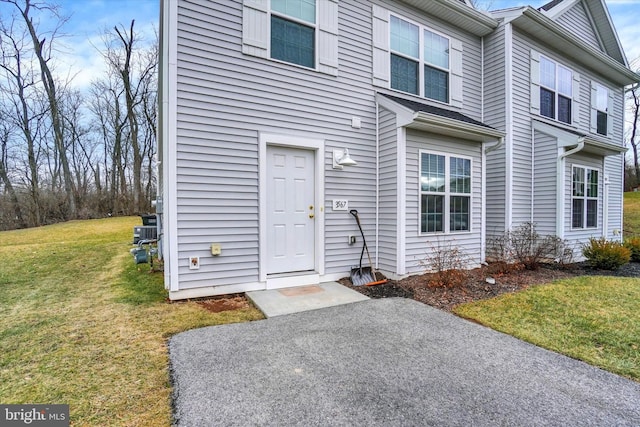 doorway to property featuring a yard