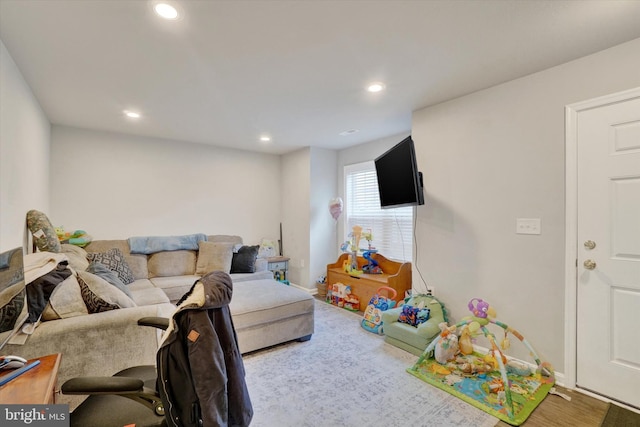 living room with recessed lighting and baseboards