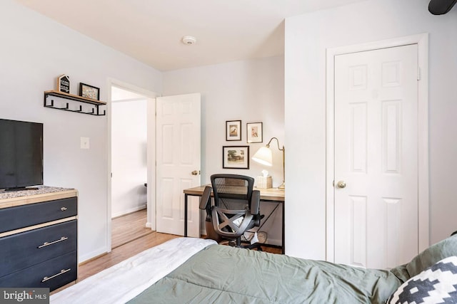 bedroom featuring light wood-style floors and baseboards